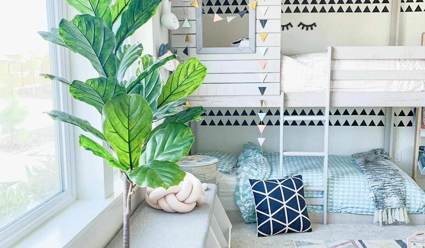 White children's bunk beds in a bright family room