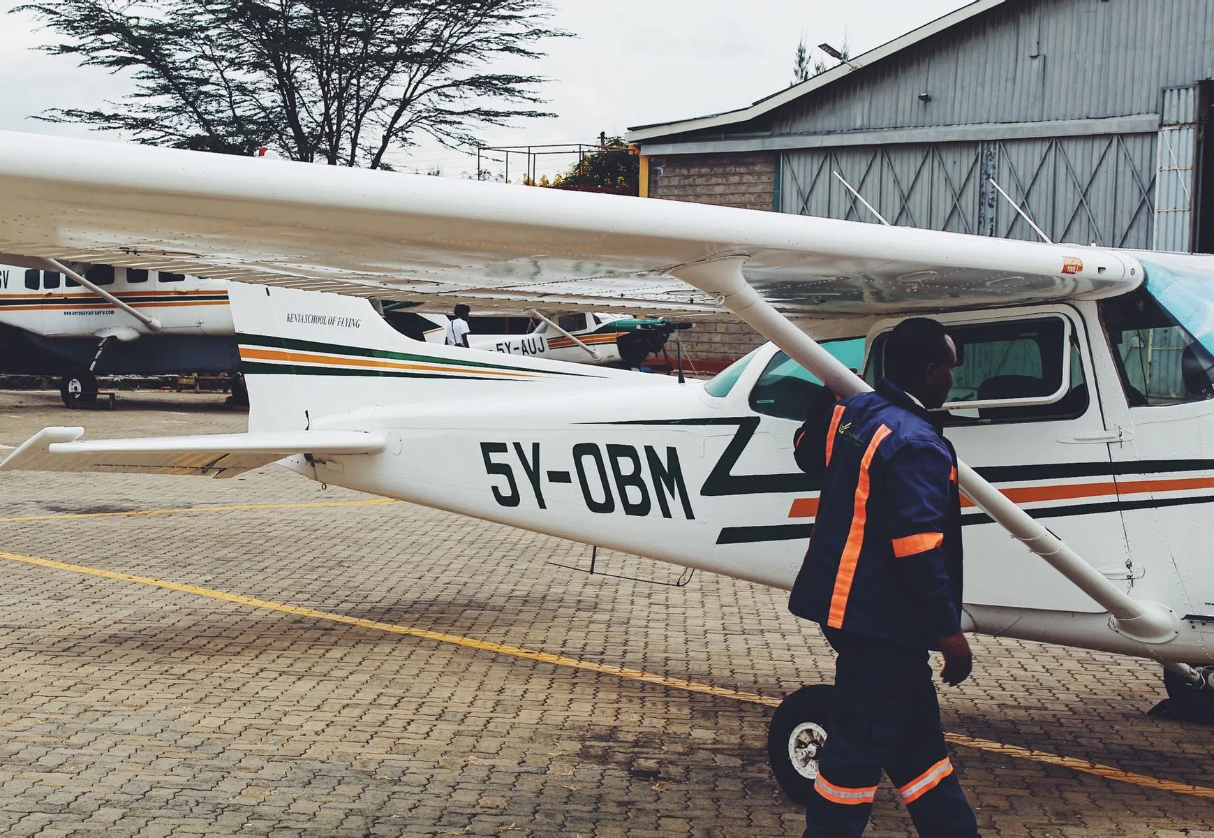Light aircraft and ground staff at a Kenyan airpark
