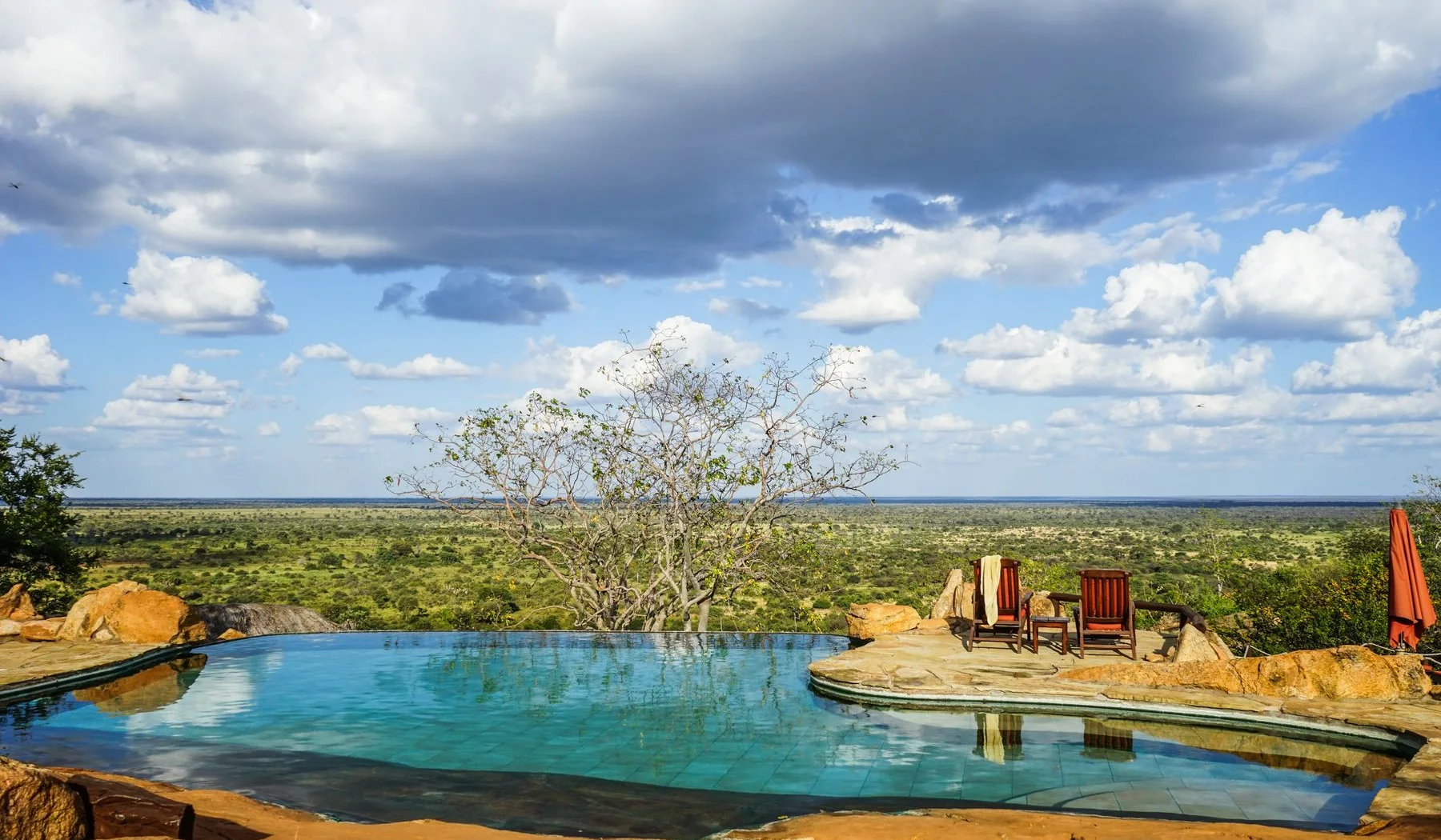 Wide view across Meru National Park from a lodge pool terrace