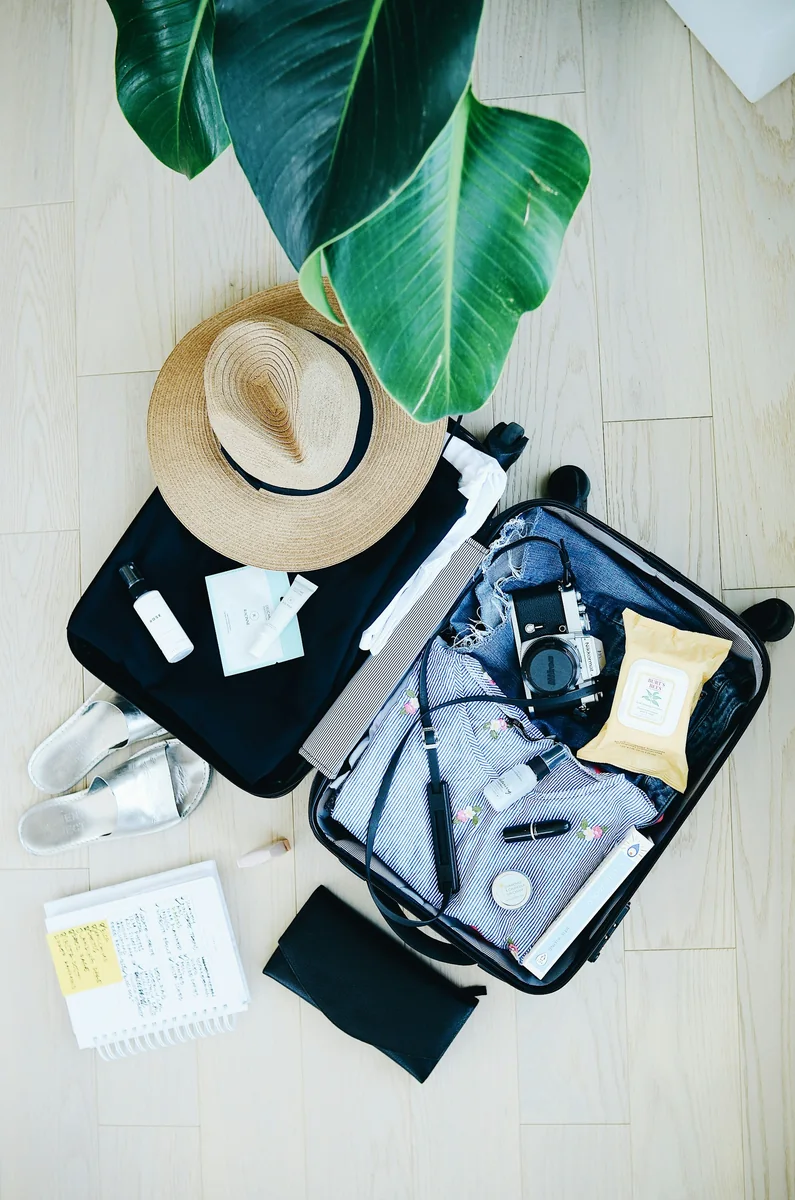 Soft safari clothing and travel items laid out for packing