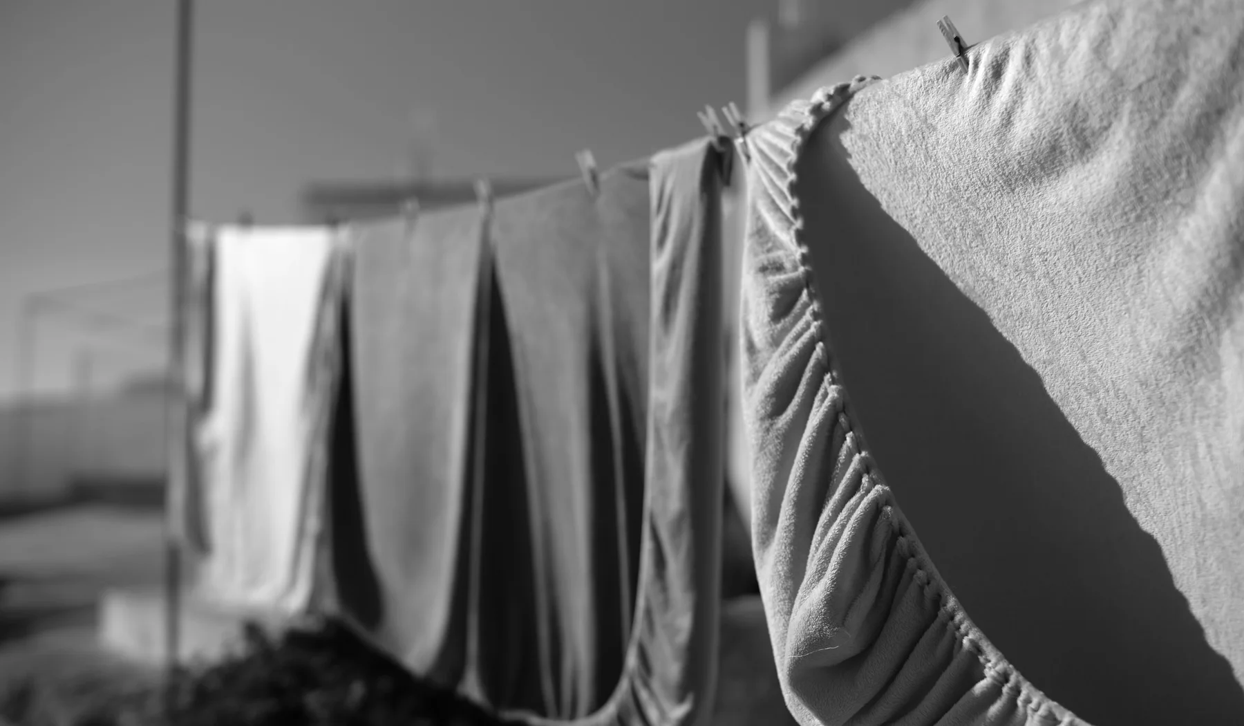 Clean linen drying on a clothesline in sunlight