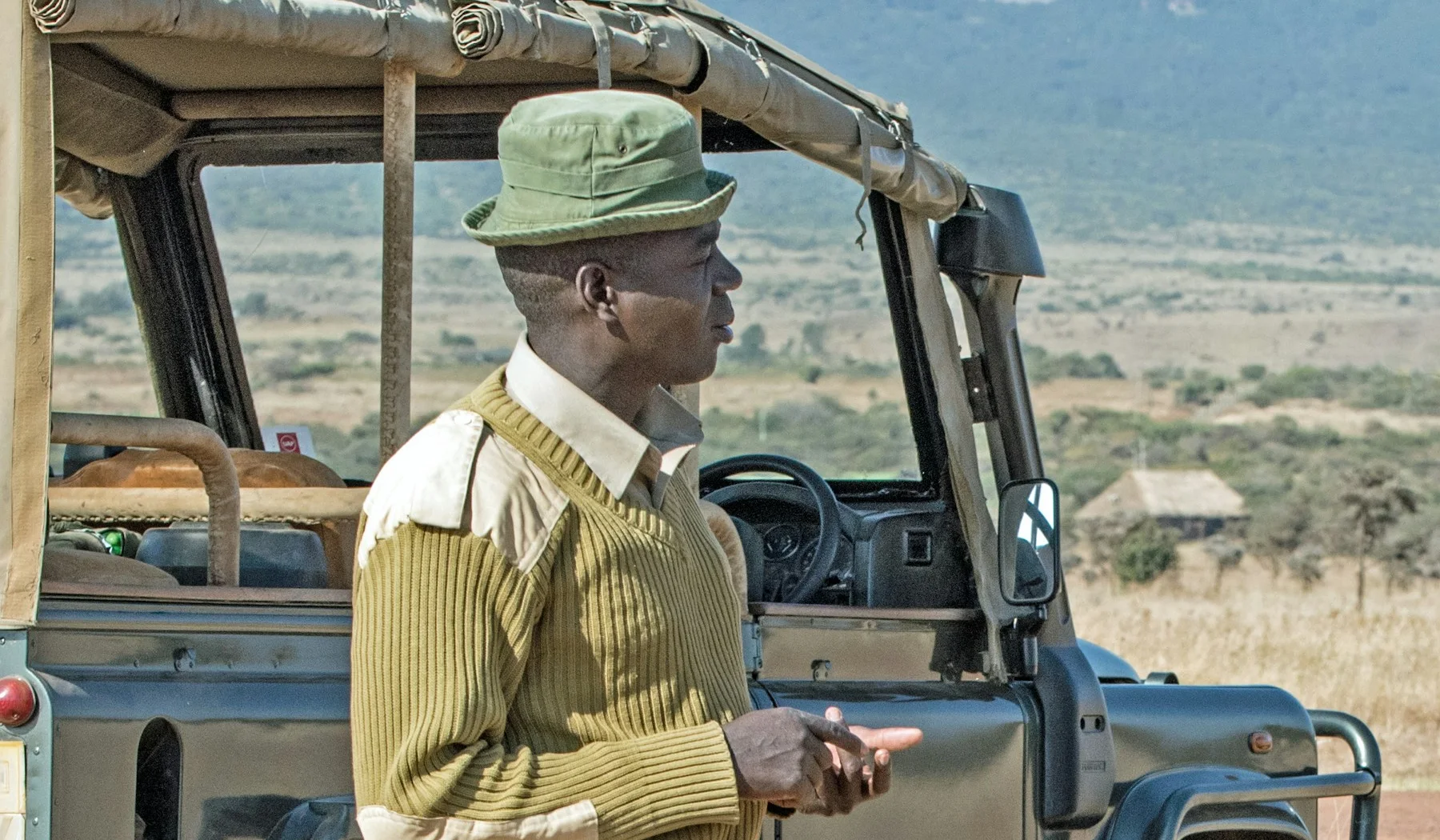 Guide Daniel beside a safari vehicle at Lewa Wildlife Conservancy, Kenya