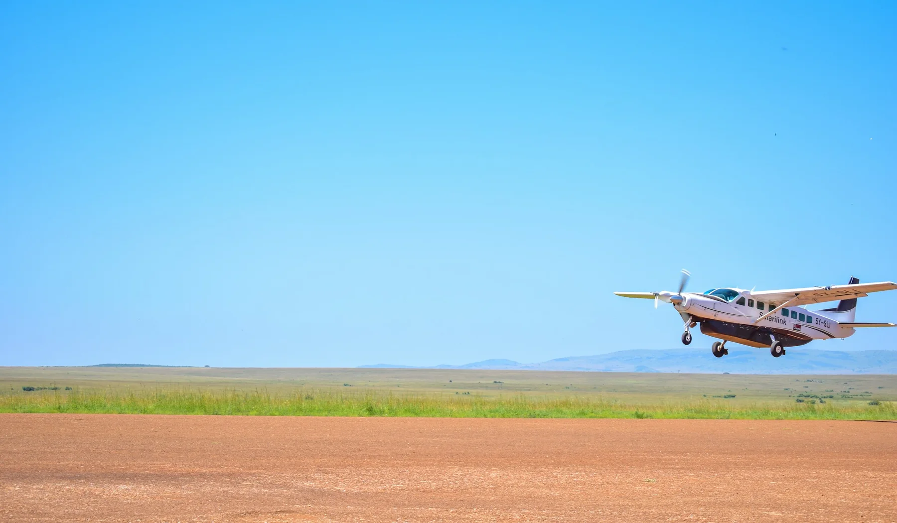 Small safari aircraft approaching a Masai Mara airstrip in Kenya