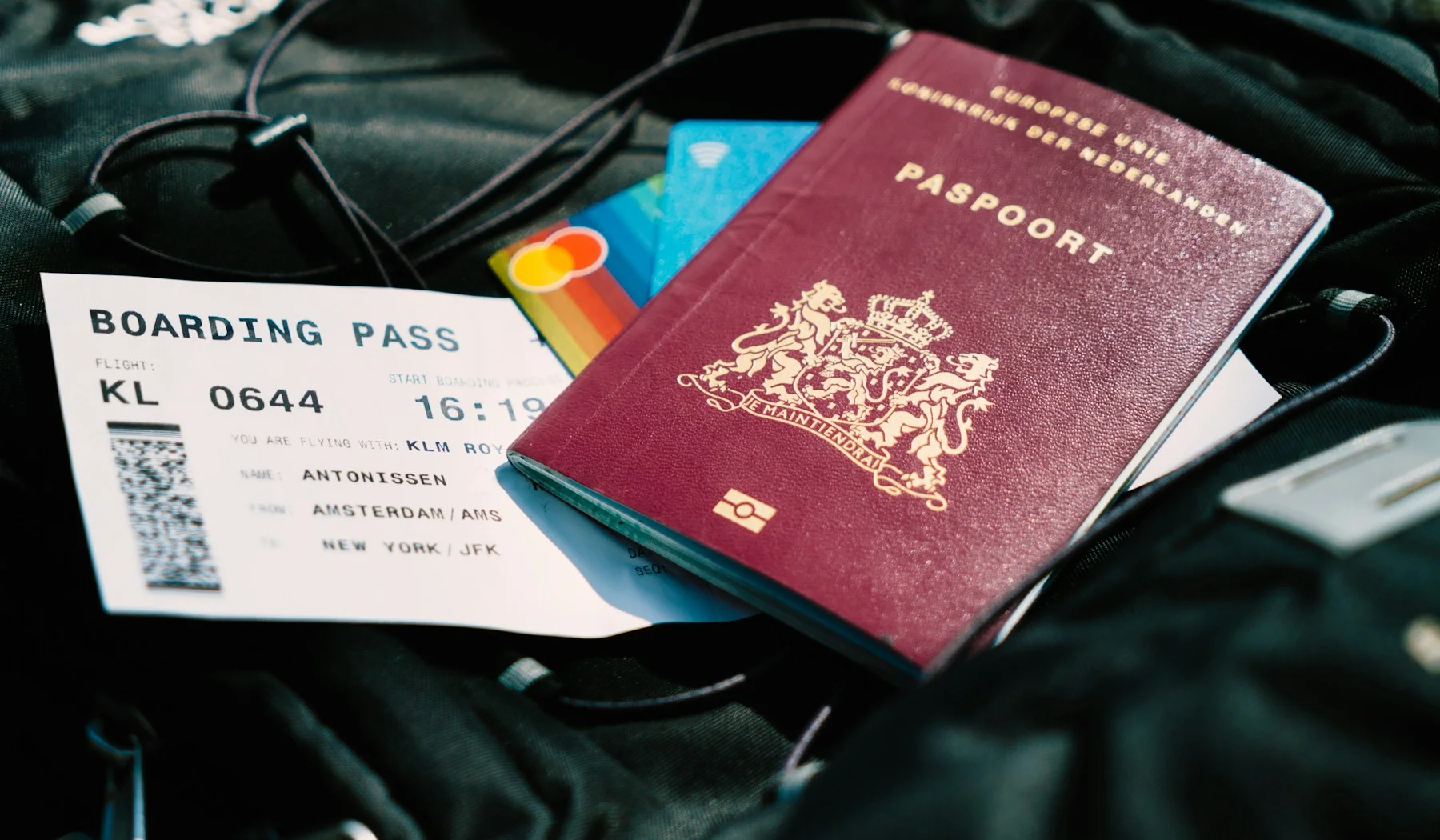 Passport, boarding pass and travel card placed on a bag