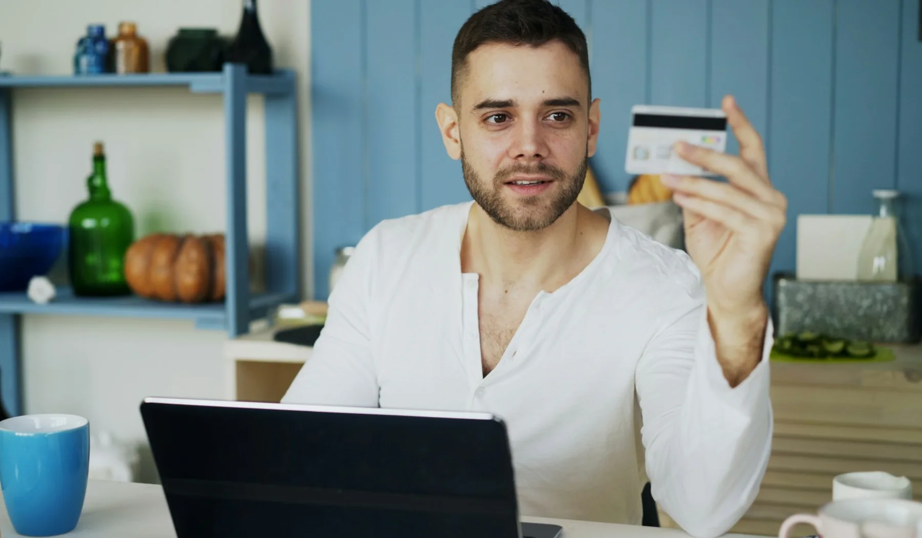 Traveller checks an online payment while holding a credit card