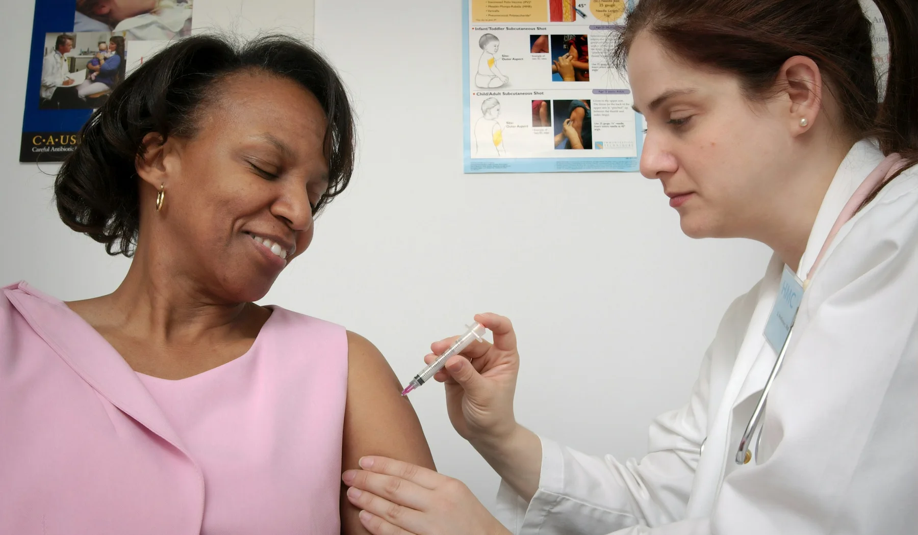 Clinician administering a vaccine in a clinic, illustrative of a pre-travel appointment